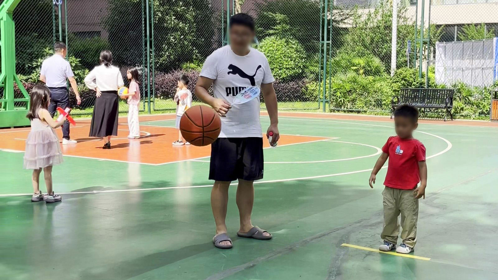 球场上,大人和孩子一起享受篮球时光